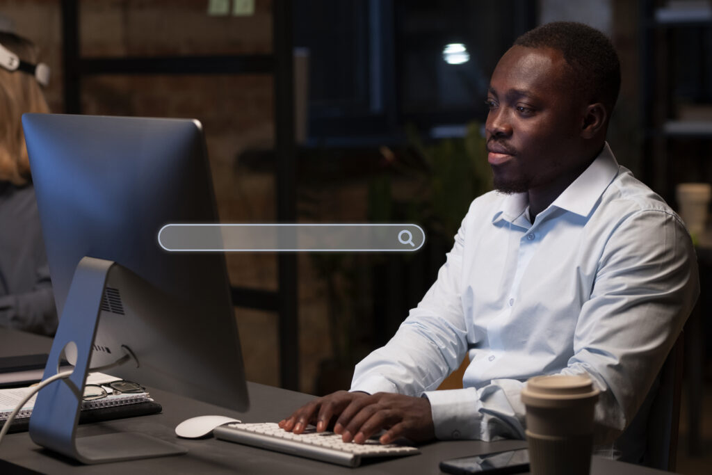 The boy wore white shirt and he searching something laptop